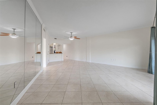 1200 N Shore Dr NE Unit 102, Saint Petersburg, FL 33701 - unfurnished living room with a ceiling fan, arched walkways, ornamental molding, and light tile patterned floors