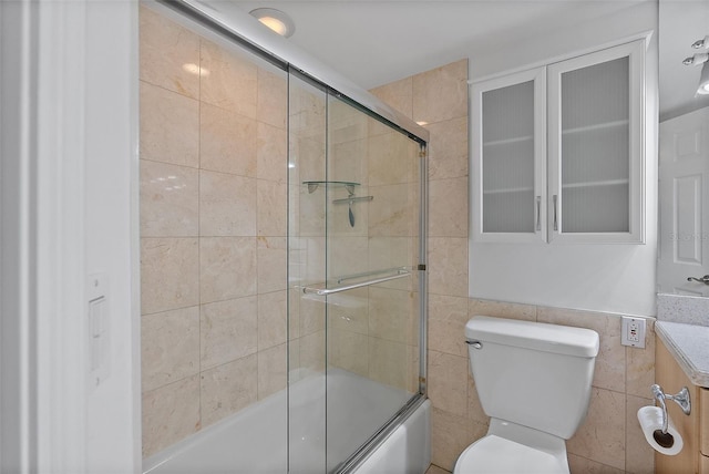 1200 N Shore Dr NE Unit 102, Saint Petersburg, FL 33701 - bathroom with shower / bath combination with glass door, tile walls, and toilet