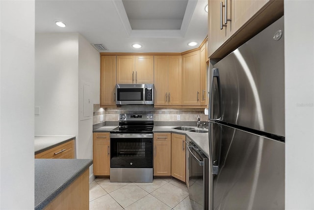 1200 N Shore Dr NE Unit 102, Saint Petersburg, FL 33701 - kitchen featuring stainless steel appliances, light brown cabinets, a sink, and decorative backsplash