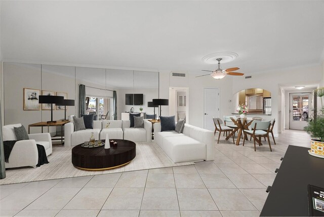 1200 N Shore Dr NE Unit 102, Saint Petersburg, FL 33701 - living room featuring light tile patterned floors, visible vents, arched walkways, a ceiling fan, and crown molding