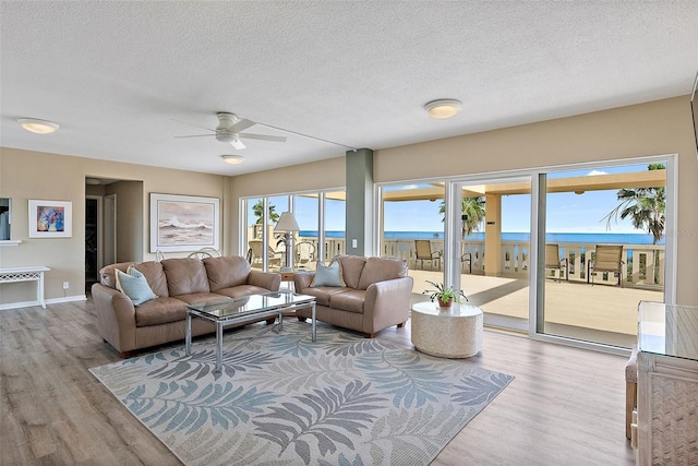 1200 N Shore Dr NE Unit 102, Saint Petersburg, FL 33701 - living area with a textured ceiling, baseboards, and wood finished floors