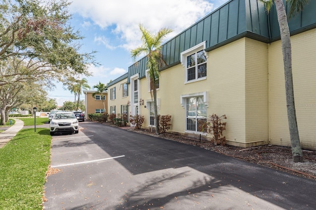 view of property with uncovered parking