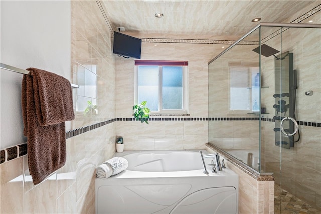 full bathroom featuring a garden tub and a shower stall