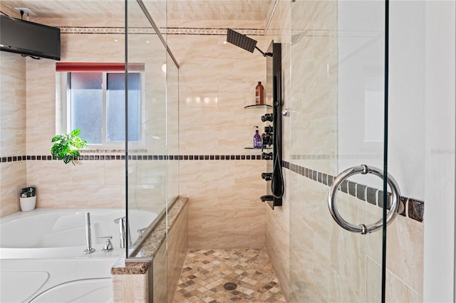 bathroom with tiled shower and a garden tub