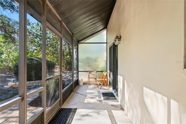 unfurnished sunroom with vaulted ceiling