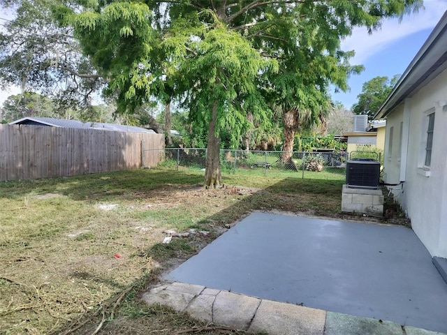 view of yard featuring a fenced backyard, cooling unit, and a patio