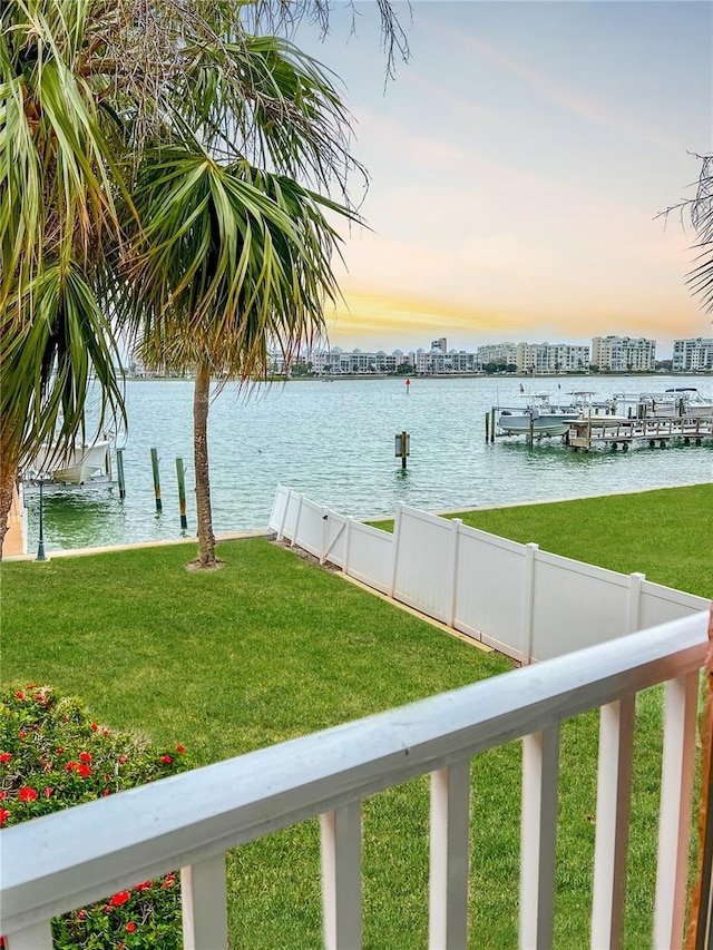 water view featuring fence and a boat dock