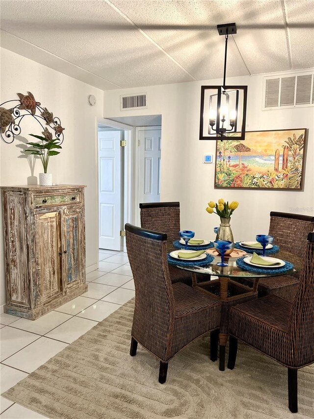 8901 Blind Pass Rd Unit 224, St Pete Beach, FL 33706 - dining space with light tile patterned floors and a chandelier