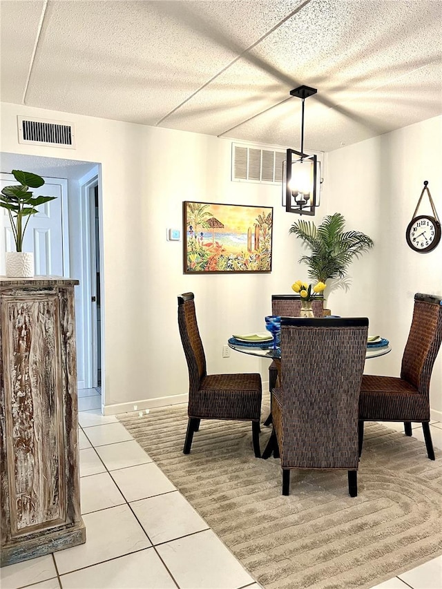 8901 Blind Pass Rd Unit 224, St Pete Beach, FL 33706 - dining space with light colored carpet, light tile patterned floors, and baseboards