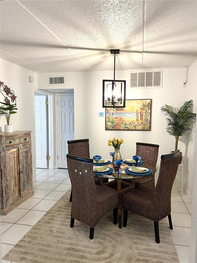 8901 Blind Pass Rd Unit 224, St Pete Beach, FL 33706 - dining area featuring light tile patterned floors and a chandelier
