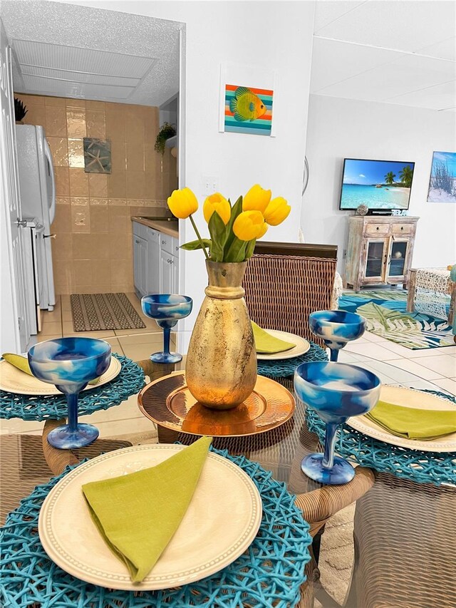 8901 Blind Pass Rd Unit 224, St Pete Beach, FL 33706 - dining area view of freestanding refrigerator and tile walls