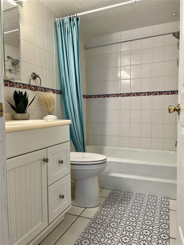 8901 Blind Pass Rd Unit 224, St Pete Beach, FL 33706 - bathroom featuring tile walls, toilet, vanity, shower / bath combo with shower curtain, and tile patterned floors