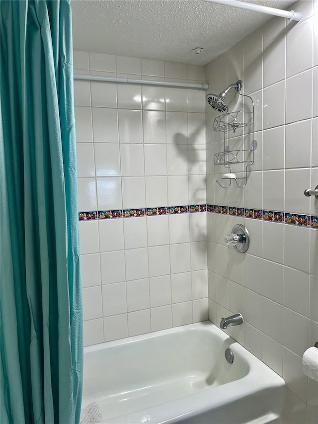 8901 Blind Pass Rd Unit 224, St Pete Beach, FL 33706 - bathroom featuring shower / bath combo with shower curtain and a textured ceiling