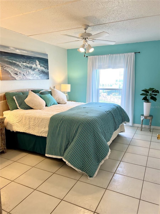 8901 Blind Pass Rd Unit 224, St Pete Beach, FL 33706 - bedroom with tile patterned floors, a ceiling fan, and a textured ceiling