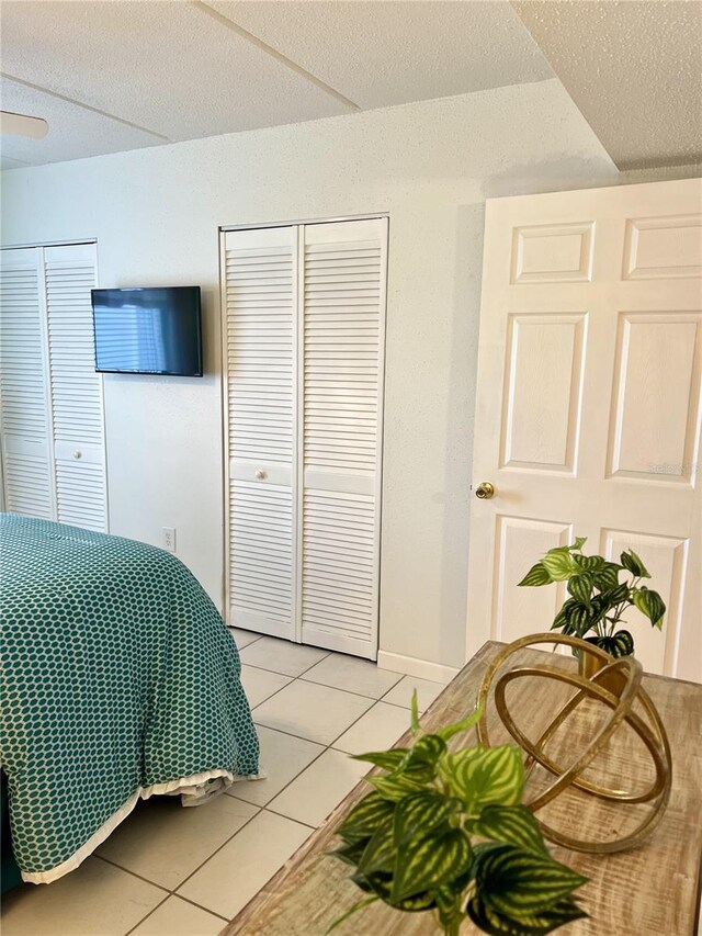 8901 Blind Pass Rd Unit 224, St Pete Beach, FL 33706 - bedroom featuring light tile patterned floors