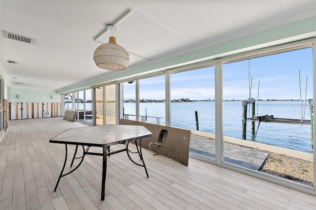 sunroom / solarium with a water view