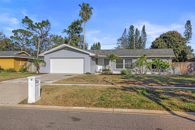 ranch-style home with a garage, fence, driveway, stucco siding, and a front lawn