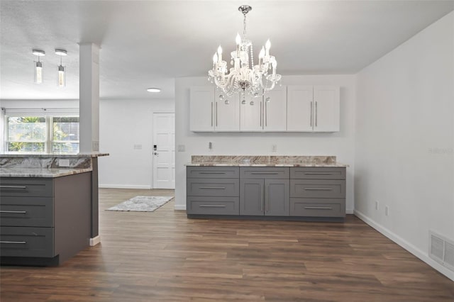 kitchen featuring visible vents, white cabinets, dark wood finished floors, decorative light fixtures, and gray cabinets