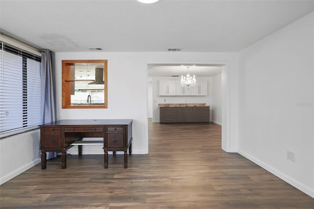 home office with dark wood-style floors, visible vents, and baseboards