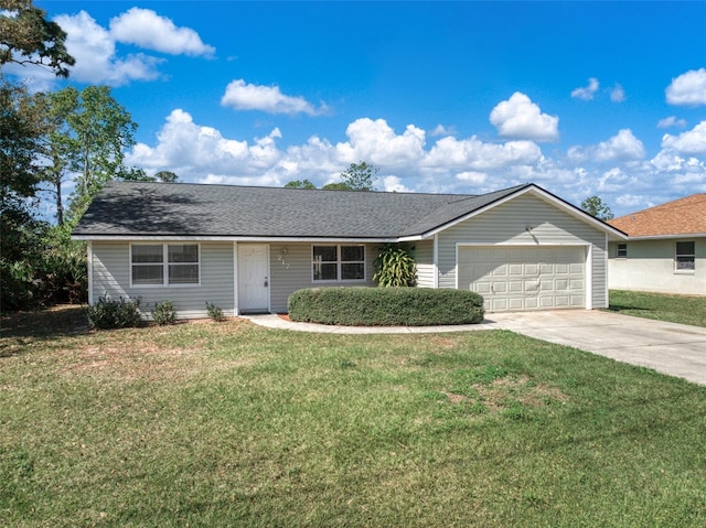 ranch-style house featuring a front yard and a garage