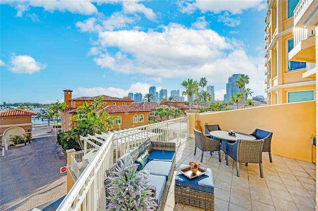 balcony featuring outdoor lounge area and a water view