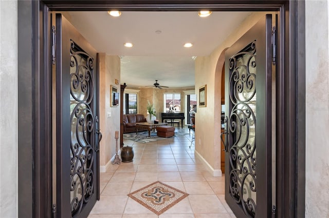 tiled foyer entrance featuring ceiling fan