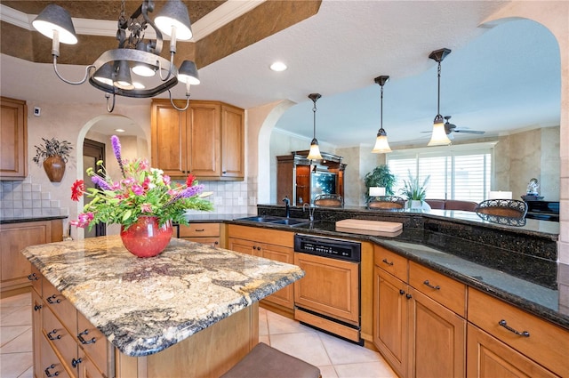 kitchen featuring a center island, decorative light fixtures, sink, dishwasher, and dark stone countertops