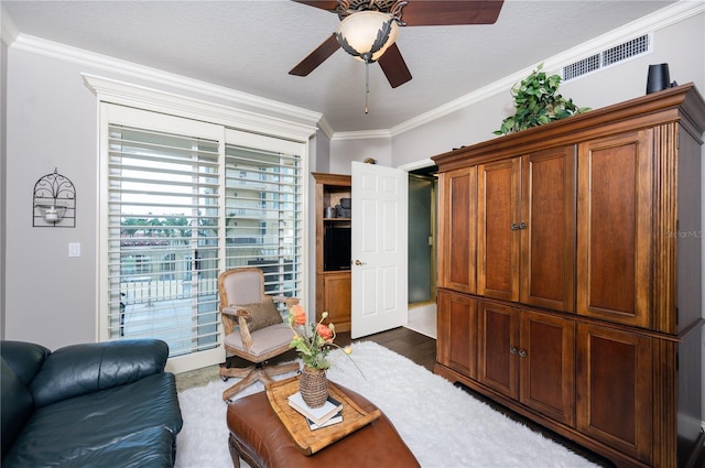 living room featuring ceiling fan, ornamental molding, and dark hardwood / wood-style floors