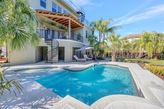 view of swimming pool featuring ceiling fan, a patio, fence, stairs, and a fenced in pool