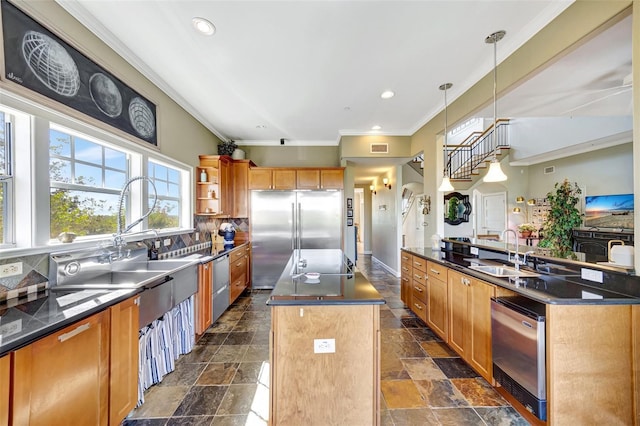 kitchen with a kitchen island, dark countertops, built in fridge, and stone tile flooring