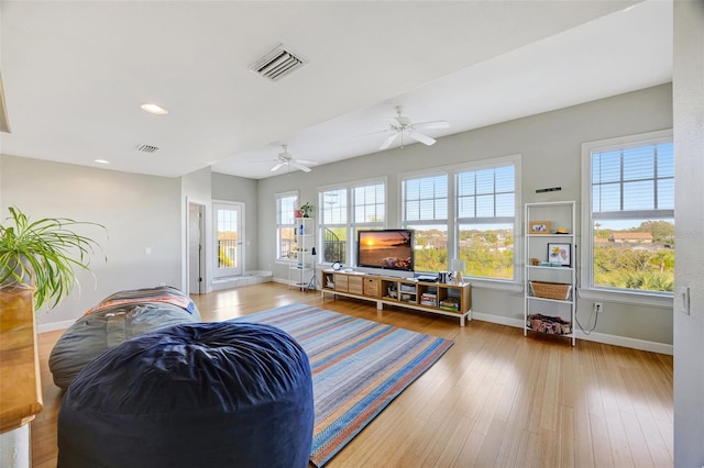 living area featuring recessed lighting, wood finished floors, visible vents, and baseboards