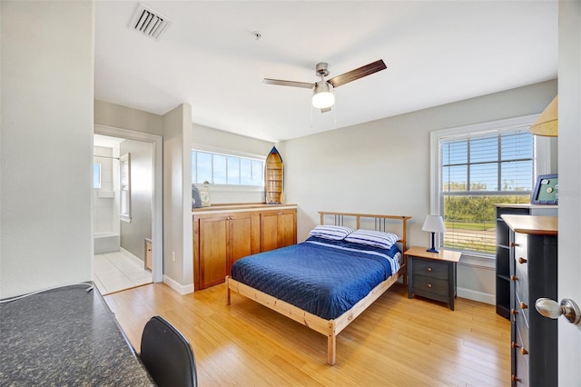 bedroom with light wood-style flooring, multiple windows, and visible vents