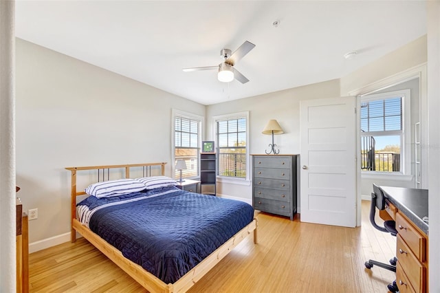 bedroom featuring light wood-style floors, baseboards, and a ceiling fan