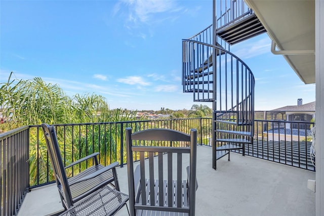 exterior space with stairs and a balcony