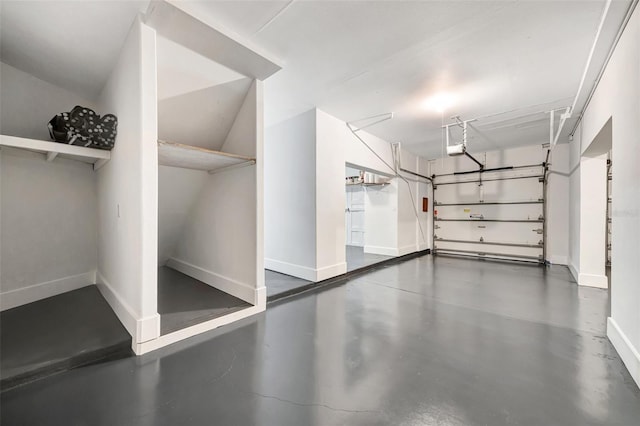 garage with a garage door opener and baseboards