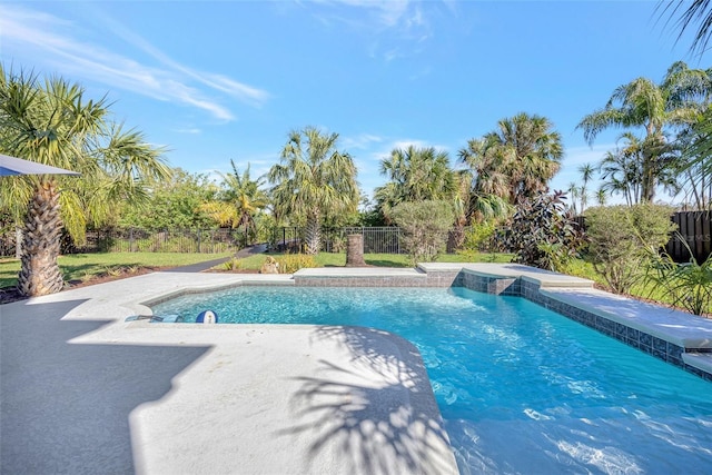 pool with a fenced backyard and a patio