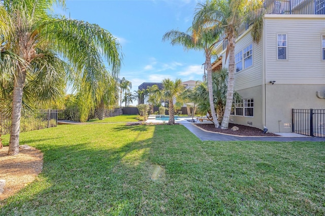 view of yard with a fenced in pool and fence