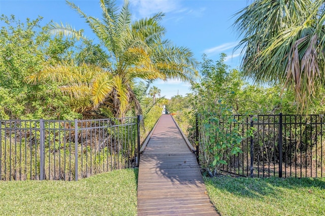 view of home's community featuring fence