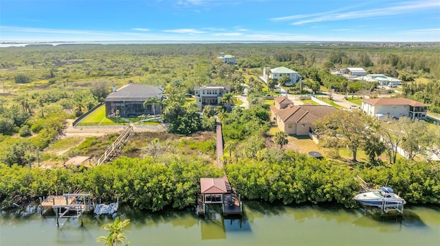 aerial view featuring a forest view and a water view