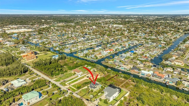 drone / aerial view featuring a water view and a residential view