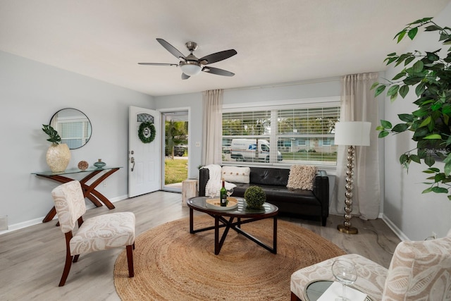 sitting room with visible vents, a ceiling fan, baseboards, and wood finished floors