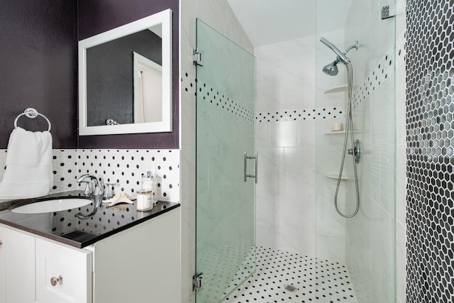 bathroom with vanity, a shower stall, and lofted ceiling