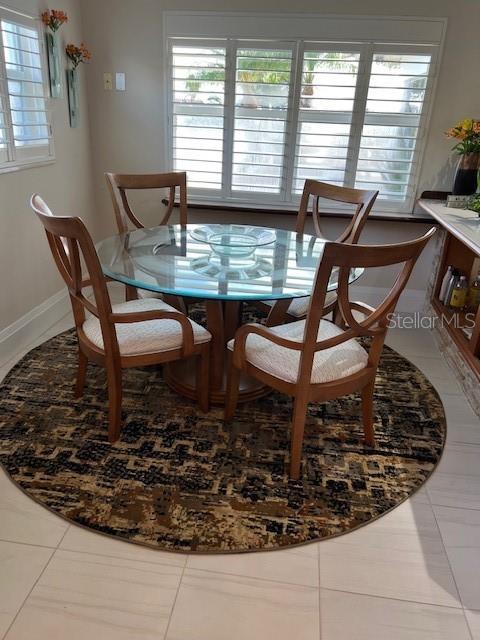 tiled dining room featuring plenty of natural light