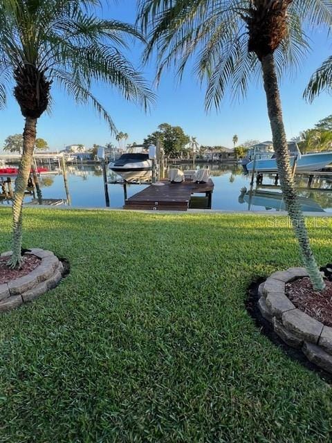 view of yard featuring a dock and a water view