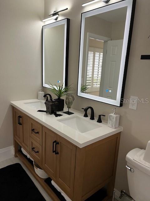 bathroom featuring vanity and toilet