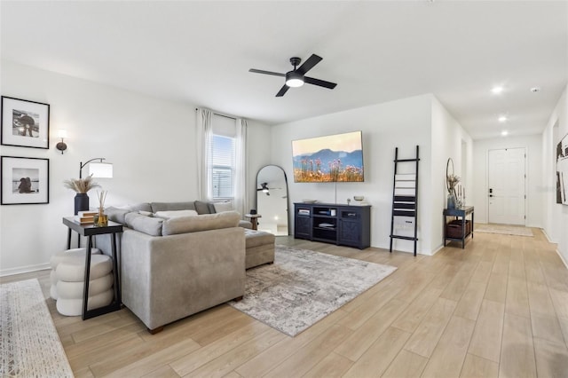 living room featuring a ceiling fan, recessed lighting, light wood-style flooring, and baseboards