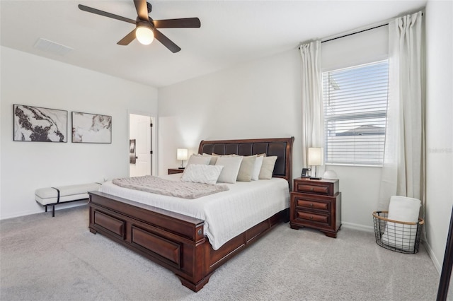 bedroom with light carpet, ceiling fan, and baseboards