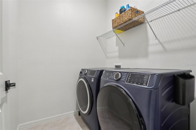 laundry area with laundry area, light tile patterned floors, baseboards, and independent washer and dryer