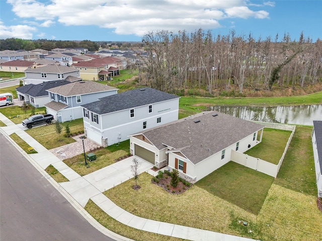 drone / aerial view featuring a water view and a residential view