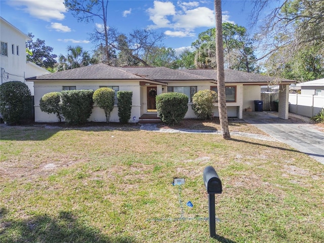 single story home featuring a carport and a front lawn